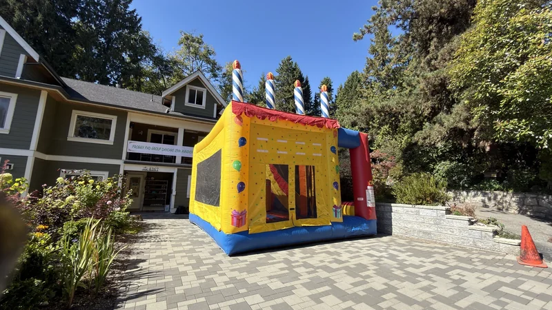 A colourful BC Event Makers bouncy castle at an outdoor celebration