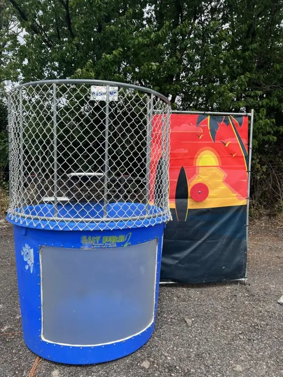 A blue dunk tank at an outdoor event