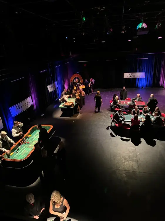 Guests around casino tables at an evening event