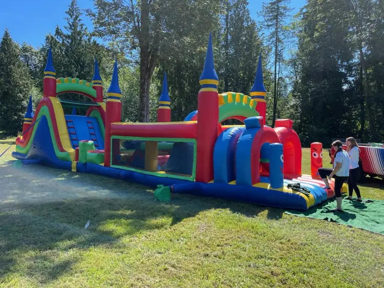 An inflatable obstacle course and slide at an outdoor event