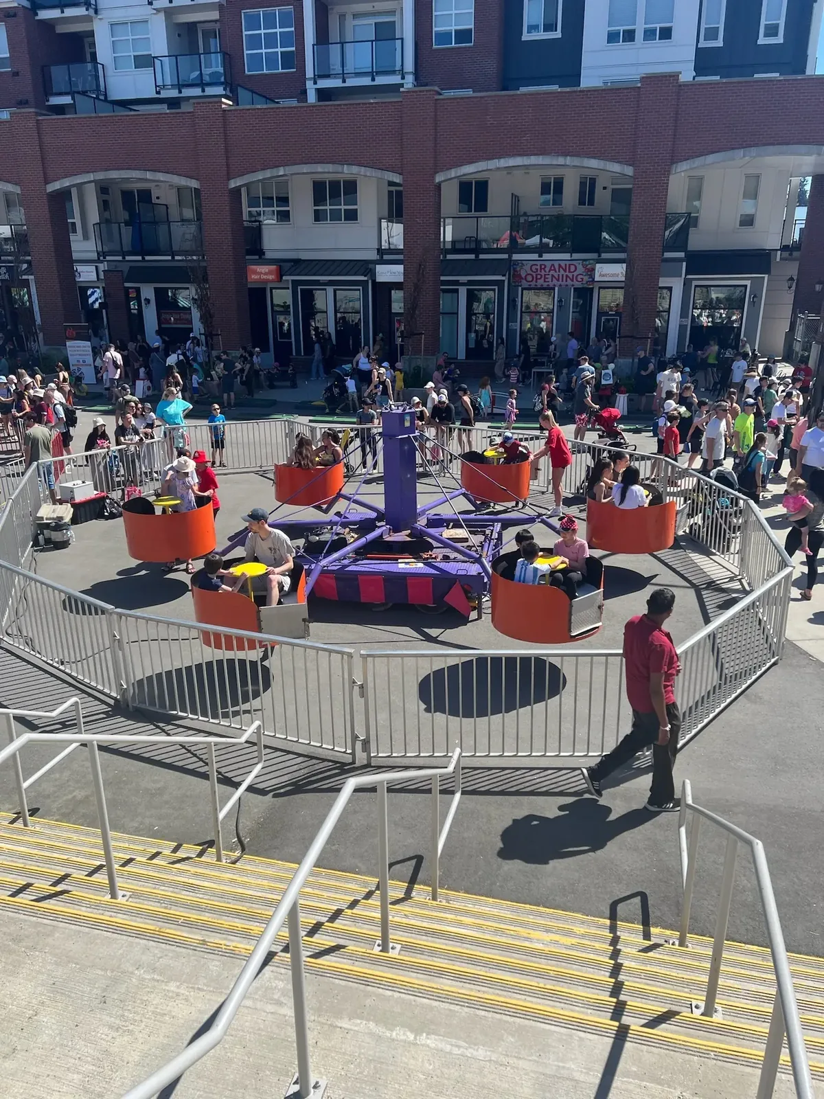 Guests in the orange spinning tubs at a community event
